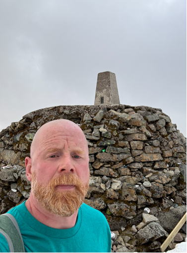 Fundraiser Luke at the summit of one of the mountains.