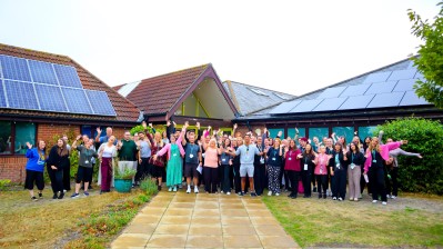 Photo of all staff infront of school